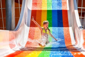 Girl on colorful waterslide